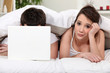 Tired woman wishing her boyfriend would turn out the lights