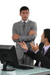 Boss having a discussion with his defensive employee