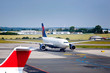 Large white commercial airplane taxiing from runway Large white commercial airplane taxiing from runway