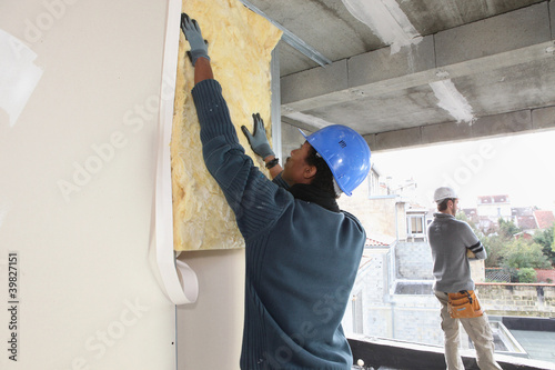 Photo: craftsman insulating a wall craftsman insulating a wall