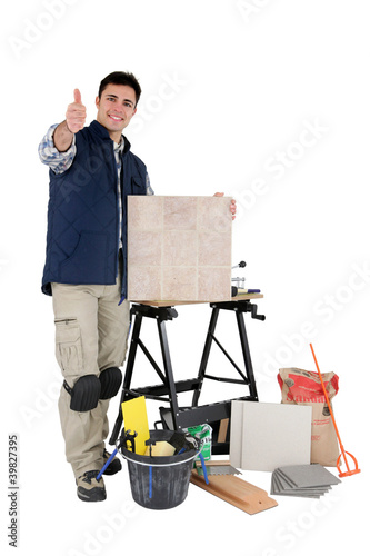 Photo: tradesman posing with his tools and building materials tradesman posing with his tools and building materials