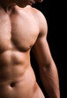 torso of young muscular man, isolated on black background torso of young muscular man, isolated on black background