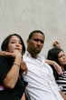 Teenagers leaning against a wall