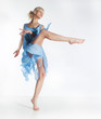 Wellness. Beautiful sexy slim woman dancing in cyan dress