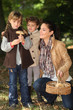Mother and daughters picking mushrooms