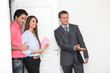 Promoter and young couple visiting a flat