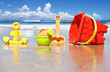 Photo: Children's beach toys at the beach - focus on watering can Children's beach toys at the beach - focus on watering can