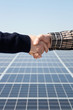 Stretta di mano davanti pannelli fotovoltaici Stretta di mano davanti pannelli fotovoltaici