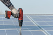 Man with screwdriver working on a photovoltaic plant Man with screwdriver working on a photovoltaic plant