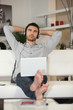 Mans listening to music through laptop