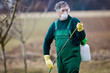 gardener applying an insecticide