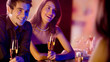 Foto: Young people with champagne at restaurant Young people with champagne at restaurant