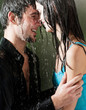 Young couple hugging under a rain