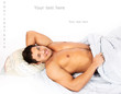Portrait of a cheerful man relaxing in his bedroom lying on his