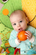 Baby with orange