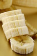 ripe banana cut into slices on a gold background ripe banana cut into slices on a gold background
