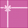 Gift bow and ribbon on purple polka dot background