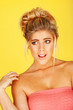 woman in a pink tube top with a shocked expression