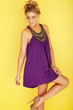 woman in a purple dress looking at her stilleto