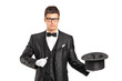 A wizard holding a magic wand and empty top hat A wizard holding a magic wand and empty top hat