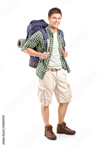 Photo: Full length portrait of a hiker with backpack posing Full length portrait of a hiker with backpack posing