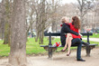 Happy romantic couple hugging on a bench