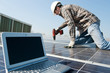 worker with scredriver and laptop on a photovoltaic plant worker with scredriver and laptop on a photovoltaic plant