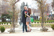 Dating couple hugging under beautiful arch