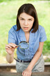Young woman with magnifier