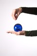 woman hand detail with a blue ball on her palm