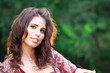 Pretty Young Woman Outdoors Smiles at Camera