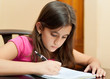 Cute hispanic girl studying at home