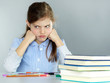Cute little child is stressed out to do her homework