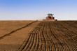 Agriculture tractor sowing seeds and cultivating field