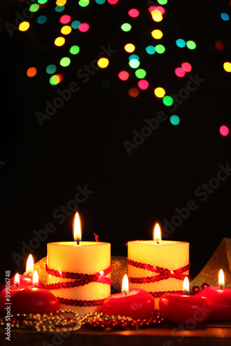 Photo: Beautiful candles on wooden table on bright background Beautiful candles on wooden table on bright background