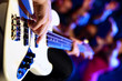 Young guitar player performing in night club