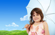Young baby girl with umbrella, green fresh spring meadow