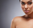 Portrait of a young and beautiful woman over grey