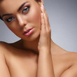 Portrait of a young and beautiful woman over grey