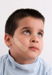 dhesive bandage on face of a child