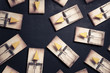 multiple mouse traps with cheese on a dark background
