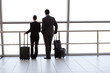 Photo: silhouette of two businesspeople at airport silhouette of two businesspeople at airport