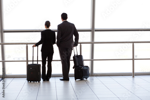Photo: silhouette of two businesspeople at airport silhouette of two businesspeople at airport