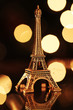 Miniature Eiffel-tower with defocused spot lights in background Miniature Eiffel-tower with defocused spot lights in background