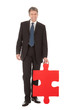 Senior businessman holding a jigsaw puzzle