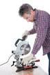 Worker cutting timber using circular saw