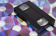 Photo: CD vs VHS. VHS cassette lay on the many CD disks CD vs VHS. VHS cassette lay on the many CD disks