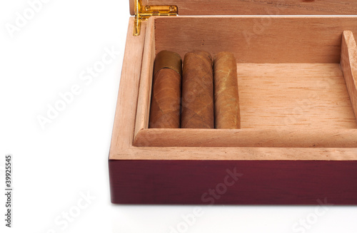 Photo: A part of Opened humidor with cigars isolated on white backgroun A part of Opened humidor with cigars isolated on white backgroun