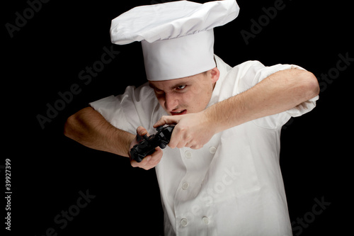 Photo: male cook playing the computer game with controller male cook playing the computer game with controller