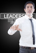 Businessman pushing Leadership word on a touch screen interface.
